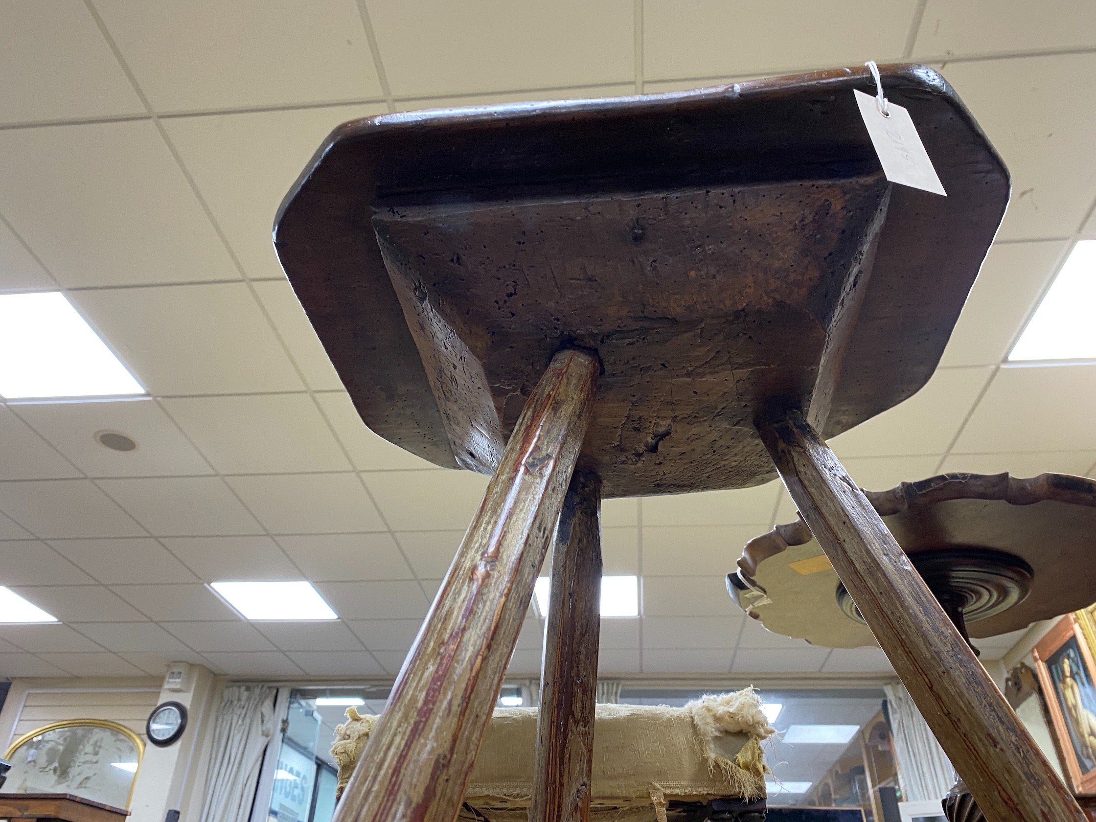 An 18th century Primitive ash and pine cricket table
